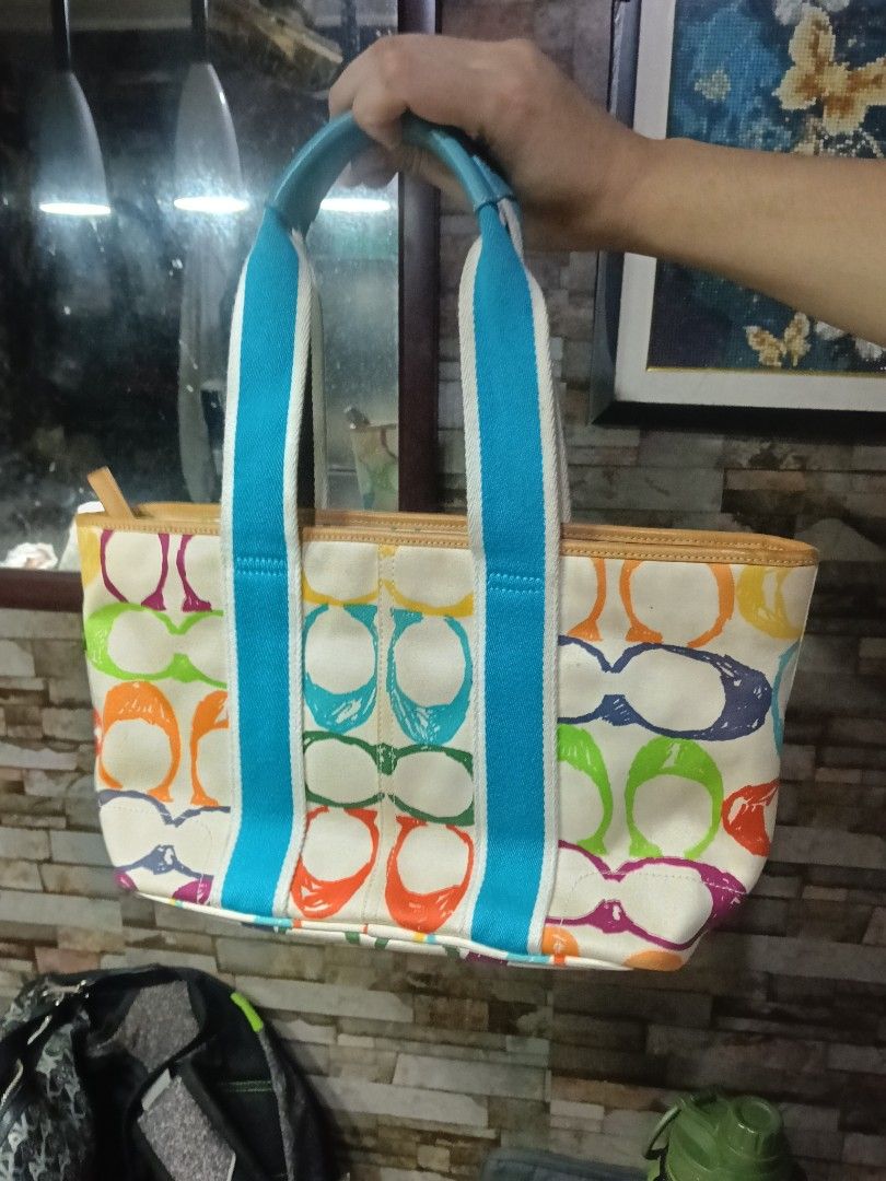 Coach Signature Multicolor Canvas Tote Bag (Category: Luxury Bags & Wallets) located in Quezon City. Submitted by bshoppe_ (Listing ID 1460585356, Image 2). Description: - Authentic Coach tote bag - Signature C print with multicolor design - Vibrant blue interior lining - Blue and white fabric handles with leather trim - Spacious interior for essentials - Ideal for everyday use - in excellent condition .