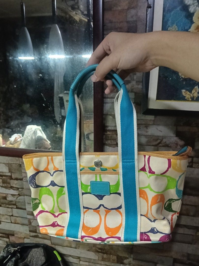 Coach Signature Multicolor Canvas Tote Bag (Category: Luxury Bags & Wallets) located in Quezon City. Submitted by bshoppe_ (Listing ID 1460585356, Image 1). Description: - Authentic Coach tote bag - Signature C print with multicolor design - Vibrant blue interior lining - Blue and white fabric handles with leather trim - Spacious interior for essentials - Ideal for everyday use - in excellent condition .