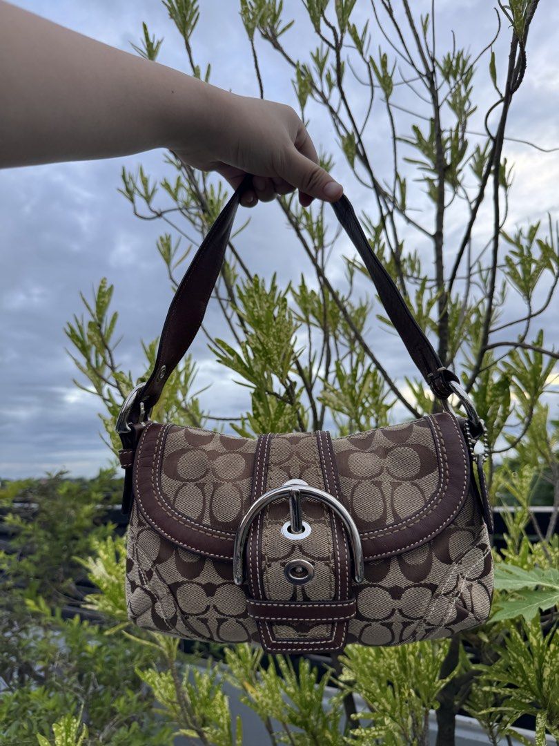 Coach Soho Canvas Shoulder Bag (Category: Shoulder Bags) located in Cabanatuan. Submitted by dgbordador (Listing ID 1460609788, Image 2). Description: - Vintage Coach shoulder bag - Color: Brown canvas with leather trim - Features a silver buckle detail on the front flap - Comes with OG dust bag and authenticity card - Has minor issue but barely noticeable naman .