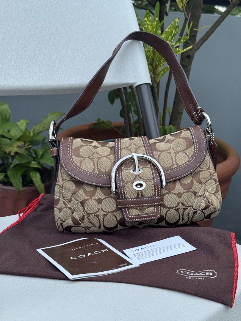 Coach Soho Canvas Shoulder Bag (Category: Shoulder Bags) located in Cabanatuan. Submitted by dgbordador (Listing ID 1460609788, Image 1). Description: - Vintage Coach shoulder bag - Color: Brown canvas with leather trim - Features a silver buckle detail on the front flap - Comes with OG dust bag and authenticity card - Has minor issue but barely noticeable naman .