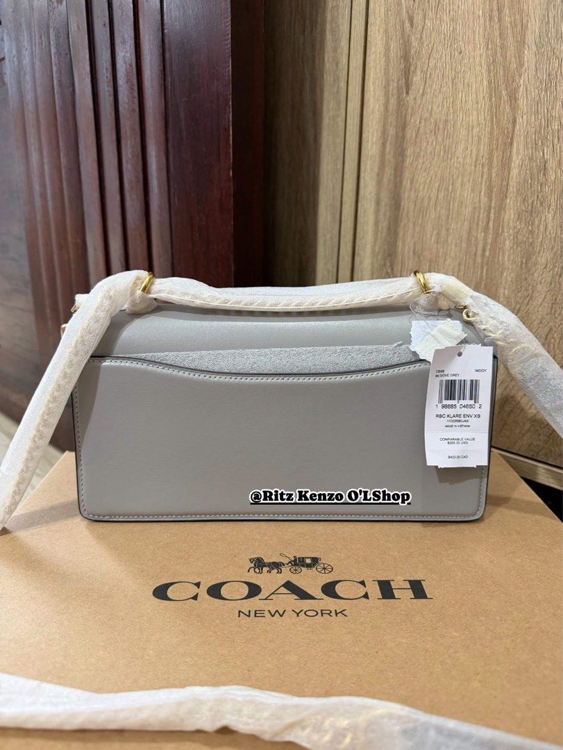 Coach Wallet On Chain Grey Leather (Category: Shoulder Bags) located in Antipolo. Submitted by ritzkenzo_olshop06 (Listing ID 1460536981, Image 2). Description: - Authentic Coach Wallet on Chain - Color: Grey - Material: Genuine Leather - Features: Main compartment, inner zip pocket - Closure: Magnetic snap - Includes: Dust bag and box - Ideal for carrying essentials.