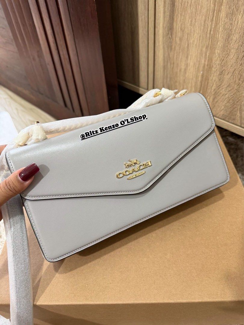 Coach Wallet On Chain Grey Leather (Category: Shoulder Bags) located in Antipolo. Submitted by ritzkenzo_olshop06 (Listing ID 1460536981, Image 3). Description: - Authentic Coach Wallet on Chain - Color: Grey - Material: Genuine Leather - Features: Main compartment, inner zip pocket - Closure: Magnetic snap - Includes: Dust bag and box - Ideal for carrying essentials.