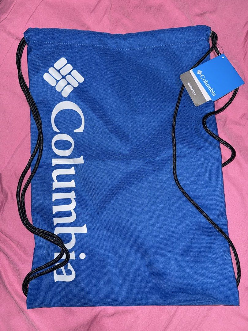 Columbia Blue Drawstring Bag (Category: Backpacks) located in Taguig. Submitted by bader05 (Listing ID 1460572658, Image 1). Description: - Blue Columbia drawstring bag - Features printed Columbia logo on the front - Interior is also blue - Comes with an attached warranty tag - Perfect for gym sessions or everyday errands.