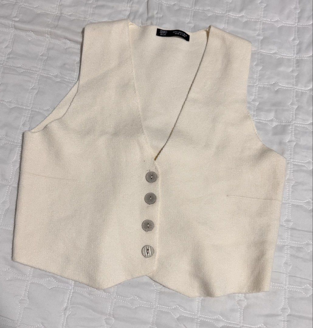 Cream Knit Vest (Category: Vests) located in Manila. Submitted by wildlion_020304 (Listing ID 1460672291, Image 1). Description: - Color: Cream - Style: Knit Vest - Neckline: V-neck - Closure: Four button front - Pockets: Two faux pockets - Estimated Size: S - Features: Great layering piece.