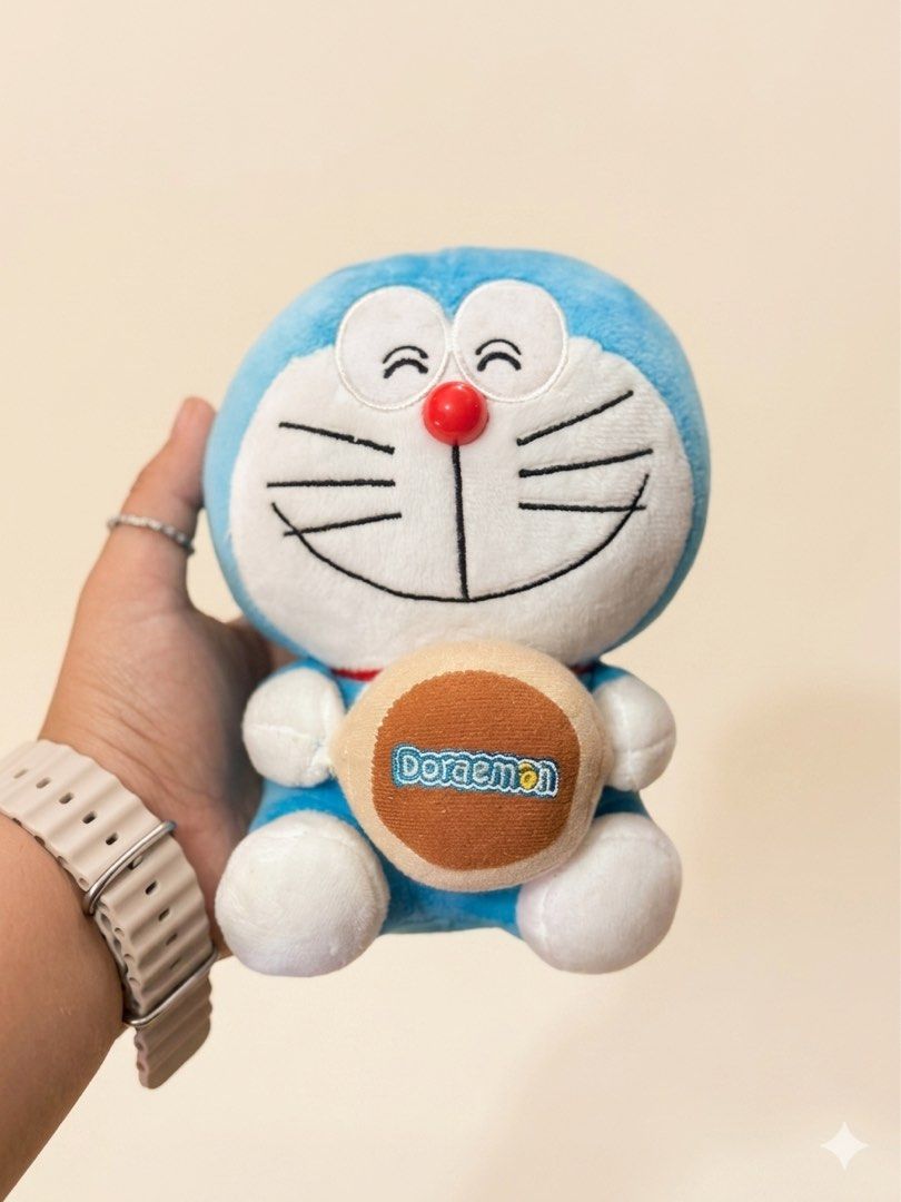 Cute Doraemon Plush Toy with Bell (Category: Plushies & Soft Toys) located in Baguio. Submitted by cherylcaps95 (Listing ID 1460510058, Image 1). Description: - Adorable Doraemon plush toy - Features a cute bell with Doraemon logo - Super soft and cuddly material - Ideal for Doraemon fans and collectors - Perfect for display or playtime - Approximately [insert size here if known] in size.