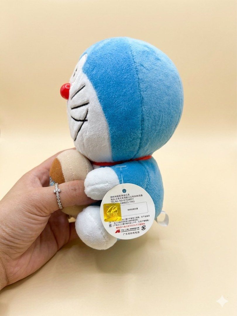 Cute Doraemon Plush Toy with Bell (Category: Plushies & Soft Toys) located in Baguio. Submitted by cherylcaps95 (Listing ID 1460510058, Image 2). Description: - Adorable Doraemon plush toy - Features a cute bell with Doraemon logo - Super soft and cuddly material - Ideal for Doraemon fans and collectors - Perfect for display or playtime - Approximately [insert size here if known] in size.
