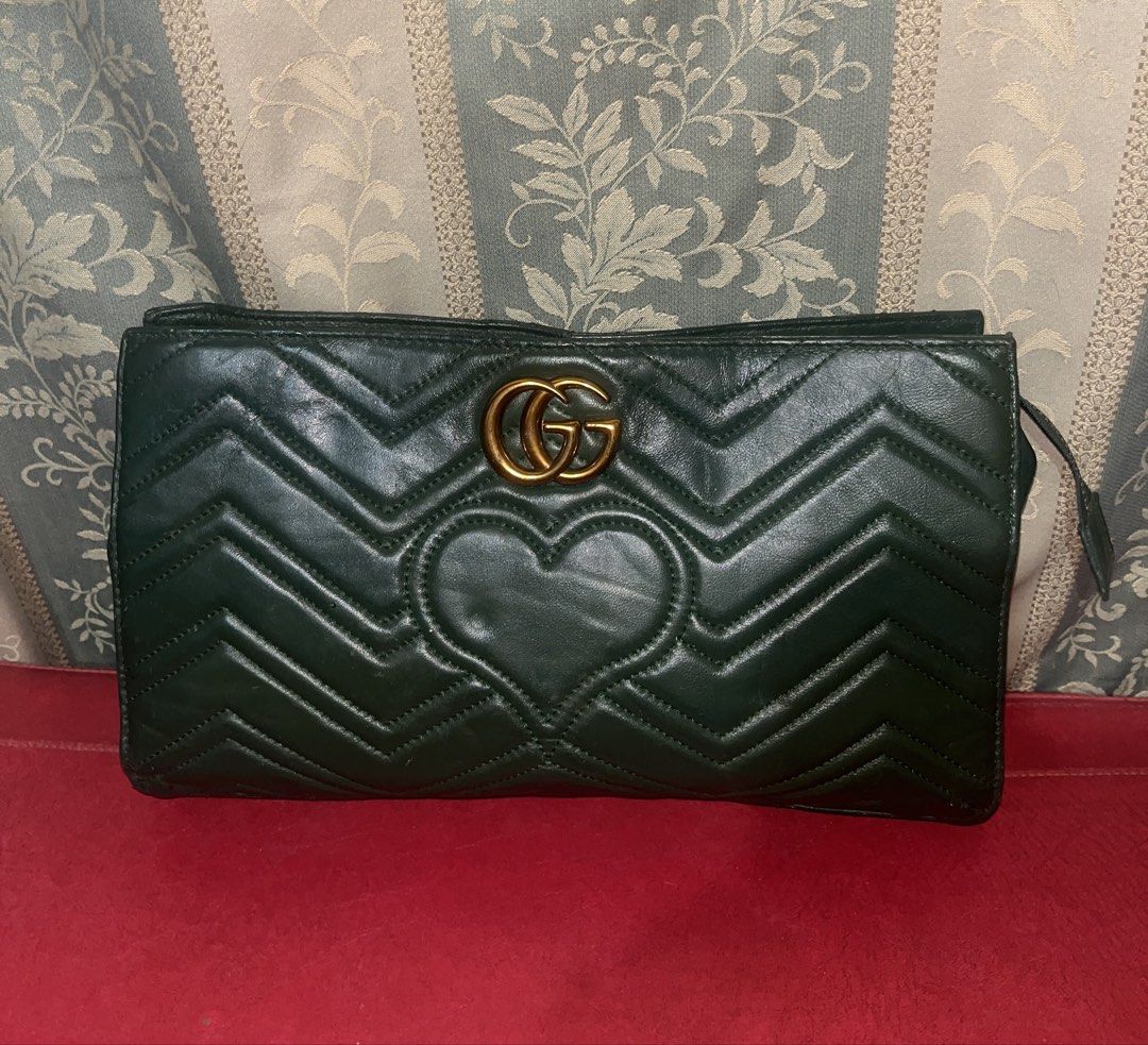 Dark green leather clutch (Category: Clutches) located in Davao. Submitted by janna_soleil (Listing ID 1460663819, Image 1). Description: dark green Gucci GG Marmont quilted leather clutch featuring a stitched heart detail on the front.