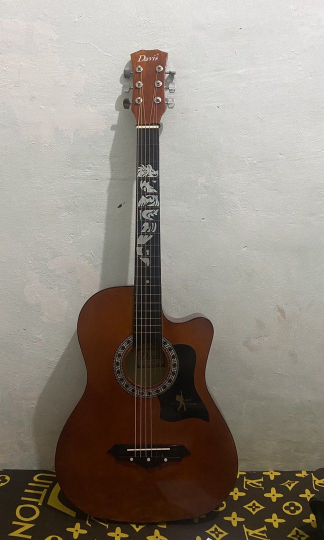 Davis Acoustic Guitar with Dragon Inlay (Category: Musical Instruments) located in Caloocan City. Submitted by suesuicidium (Listing ID 1460705923, Image 2). Description: - Davis acoustic guitar - Unique dragon inlay on fretboard - Cutaway body style - Ideal for beginners or collectors - Plays well - Reason for selling: Underutilized Inclusion - bag .