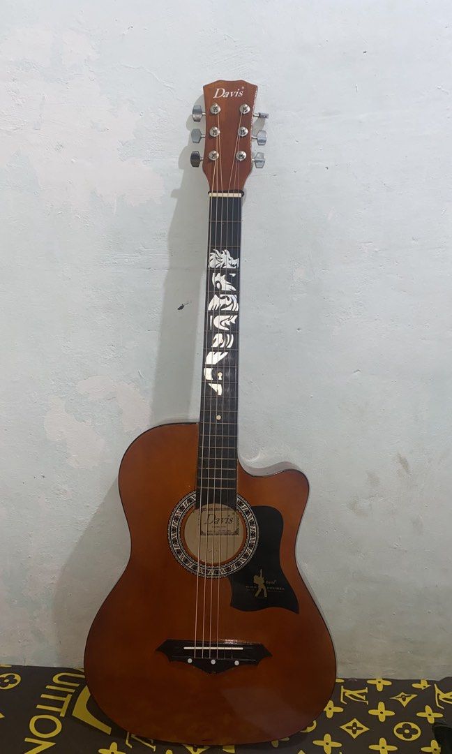 Davis Acoustic Guitar with Dragon Inlay (Category: Musical Instruments) located in Caloocan City. Submitted by suesuicidium (Listing ID 1460705923, Image 1). Description: - Davis acoustic guitar - Unique dragon inlay on fretboard - Cutaway body style - Ideal for beginners or collectors - Plays well - Reason for selling: Underutilized Inclusion - bag .