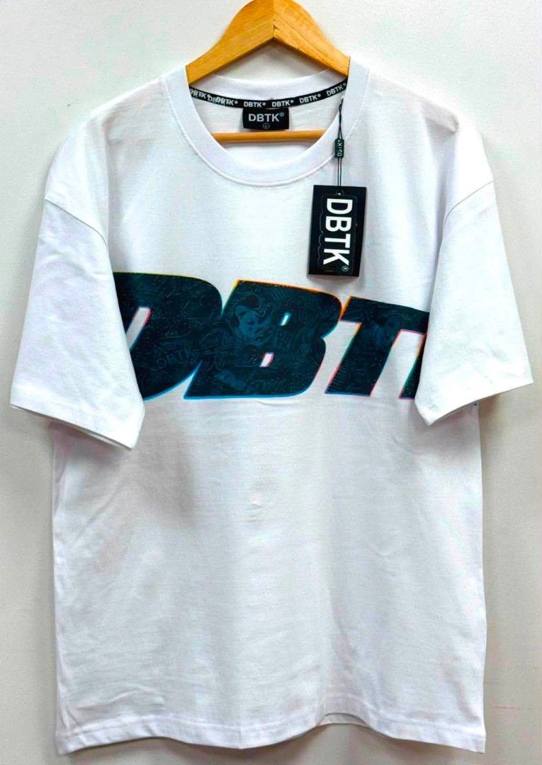 DBTK White T-shirt with Graphic Print (Category: Tshirts & Polo Shirts ) located in Cavite. Submitted by samthingtowearsimpystylish (Listing ID 1460568567, Image 1). Description: - White DBTK t-shirt ovrrns - Features bold graphic print on chest - DBTK logo on tag and neckband - Small holes noted near the hem - Ideal for casual outfits.