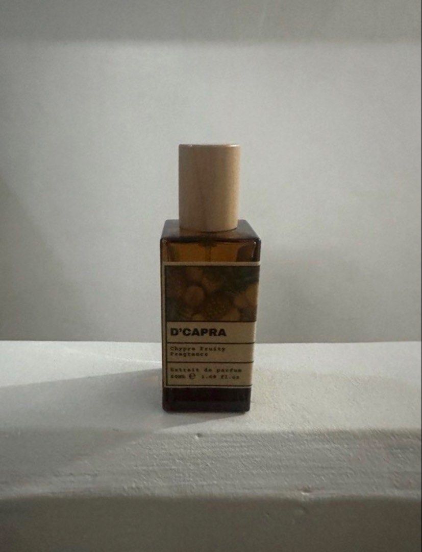 D'CAPRA (Aventus Inspired) (Category: Fragrance & Deodorants) located in Taguig. Submitted by mrndnts (Listing ID 1460655260, Image 1). Description: - D'CAPRA Chypre Fruity Fragrance - Extrait de Parfum concentration - 50ml bottle size - Elegant amber glass bottle with a wooden cap - Ideal for everyday wear.