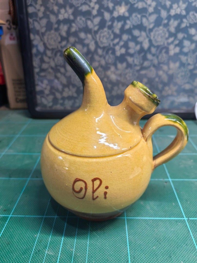 Decorative Earthenware Oil Cruet (Category: Other Kitchenware & Tableware) located in Cebu City. Submitted by dudes_villanueva (Listing ID 1460714833, Image 1). Description: Decorative Earthenware Oil Cruet In excellent condition — no cracks or chips. Product Description Decorative oil bowl with a handcrafted design. - Finished in earth and yellow tones. - Oli inscription on the body. - Handle and beak with green details. Color: Yellow, Green, an