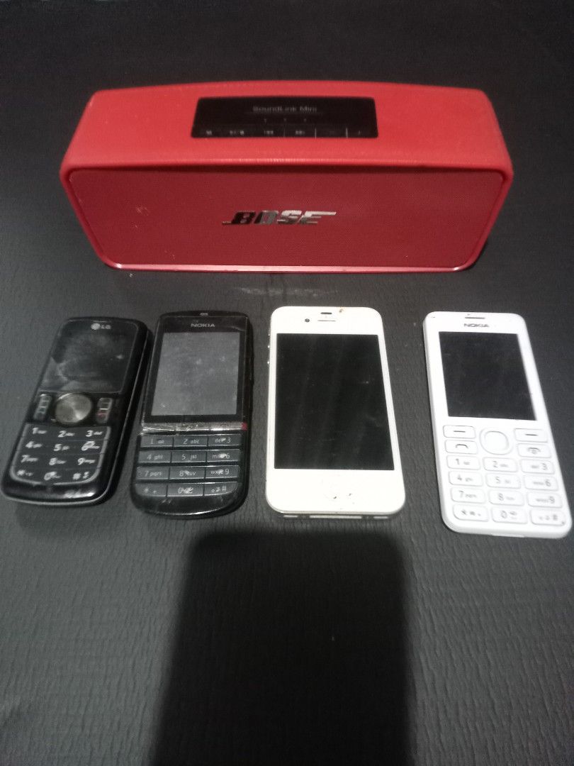 defective phone bundle (Category: Other Mobile & Gadget Accessories) located in Makati City. Submitted by pardsroman (Listing ID 1460519548, Image 1). Description: - Bundle includes: 1 LG phone, 2 Nokia phones (1 black, 1 white), 1 white iPhone - Also includes: Red Bose SoundLink Mini speaker - Condition: Defective, suitable for parts or repair - Ideal for tech enthusiasts or those needing replacement parts.