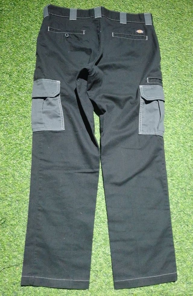 Dickies Black Cargo Pants Work wear Style with multiple utility pockets (Category: Jeans) located in Manila. Submitted by patrickjos06722 (Listing ID 1460687945, Image 2). Description: - Classic black Dickies cargo pants - Durable workwear style - Multiple pockets for convenience - Features contrast stitching - Grey pocket accents - Waist measures approx. 32 inches flat - Length is around 39 from top to bottom - Leg opening measures approx. 8 inc
