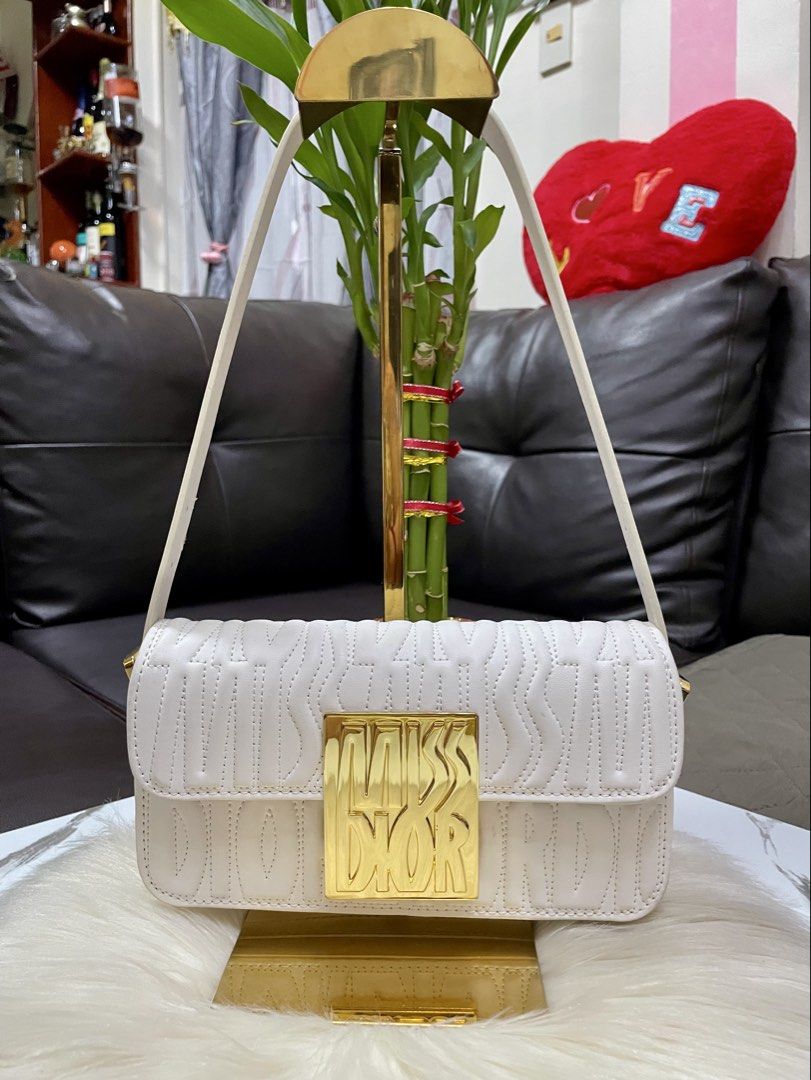 Dior (Category: Luxury Bags & Wallets) located in Mandaue City. Submitted by ludz_0246 (Listing ID 1459838947, Image 1). Description: Gold Hardware Code Etekita Logo With 2 Strap Dustabag In creamy white 22cm Good as new .