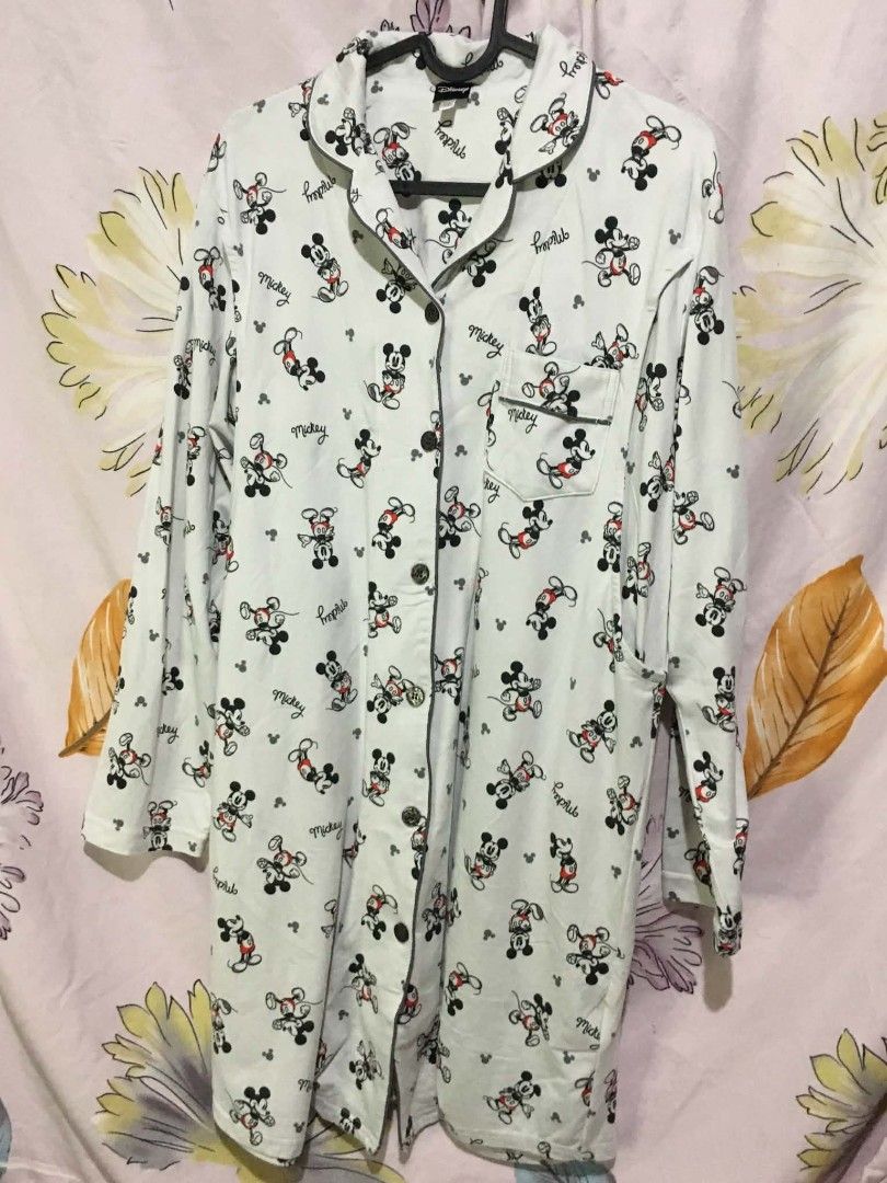 Disney Mickey Mouse Sleep Shirt (Category: Dresses) located in Manila. Submitted by jsmngrml18 (Listing ID 1460706732, Image 1). Description: Disney Mickey Mouse Sleep Shirt 🐭 - White button-down nightshirt with all-over Mickey Mouse prints and "mickey" script text - Classic collared design with grey piping, front buttons, and a chest pocket - Long sleeves, soft fabric, Disney branded — size M - Cute, comfy, and perfect for cozy nights in.