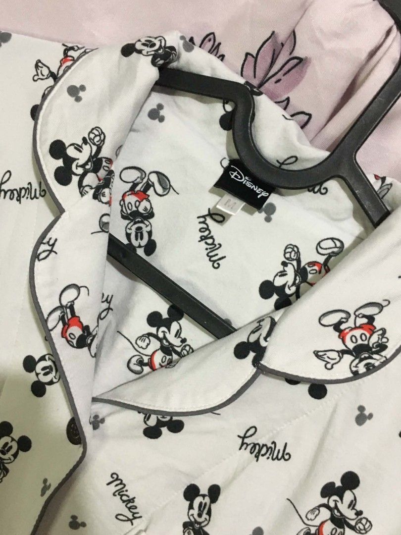 Disney Mickey Mouse Sleep Shirt (Category: Dresses) located in Manila. Submitted by jsmngrml18 (Listing ID 1460706732, Image 2). Description: Disney Mickey Mouse Sleep Shirt 🐭 - White button-down nightshirt with all-over Mickey Mouse prints and "mickey" script text - Classic collared design with grey piping, front buttons, and a chest pocket - Long sleeves, soft fabric, Disney branded — size M - Cute, comfy, and perfect for cozy nights in.