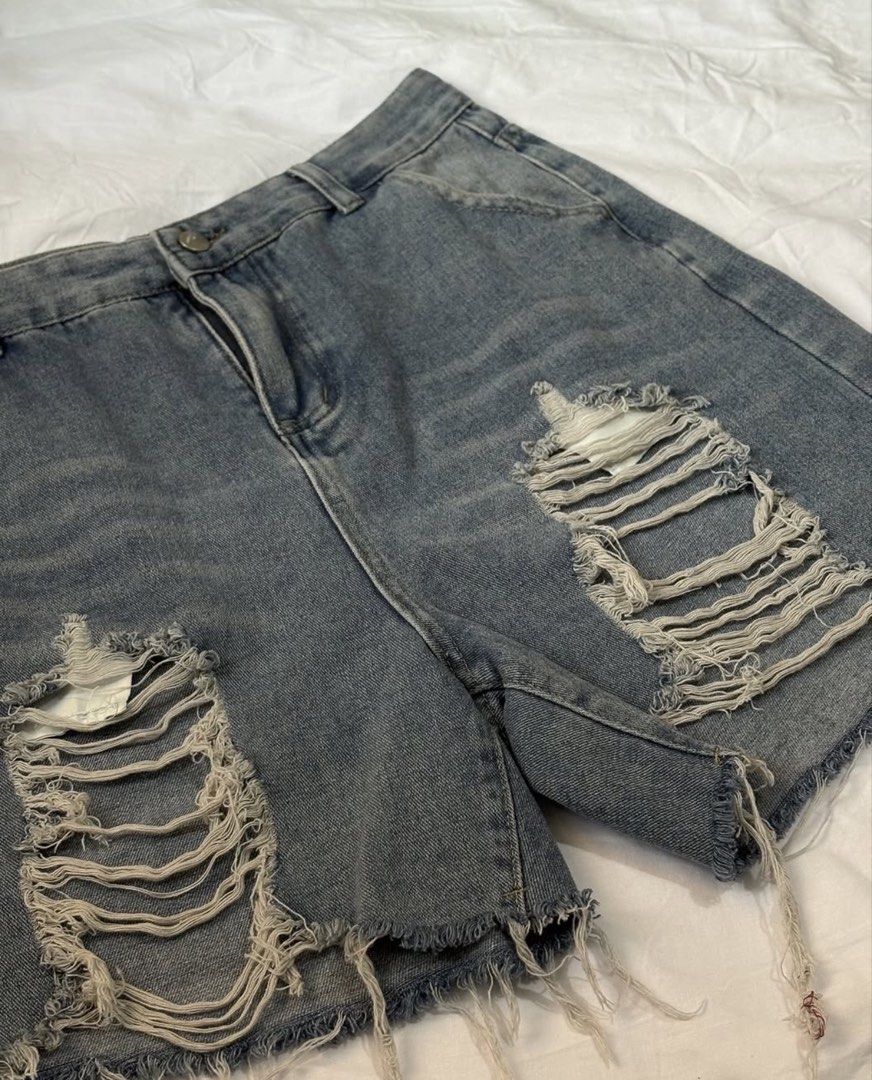 Distressed Denim Jorts (Category: Shorts) located in Manila. Submitted by thedailythreadclub (Listing ID 1460563954, Image 1). Description: - Light wash denim shorts - Ripped detailing on the front - Frayed hem - Classic five-pocket styling - Button and zip closure - Ideal for casual wear.
