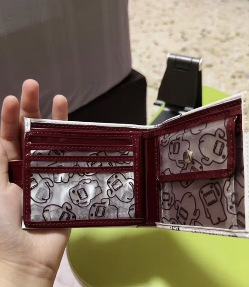 Domo Newspaper Print Bi-fold Wallet (Category: Wallets & Card holders) located in Makati City. Submitted by ellope (Listing ID 1460690389, Image 3). Description: Domo wallet with newspaper print. Has 8 card slots and coin pouch and 2 compartment for bills.