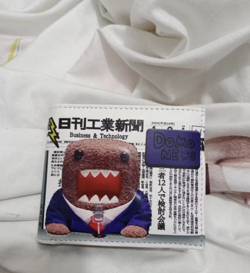 Domo Newspaper Print Bi-fold Wallet (Category: Wallets & Card holders) located in Makati City. Submitted by ellope (Listing ID 1460690389, Image 1). Description: Domo wallet with newspaper print. Has 8 card slots and coin pouch and 2 compartment for bills.