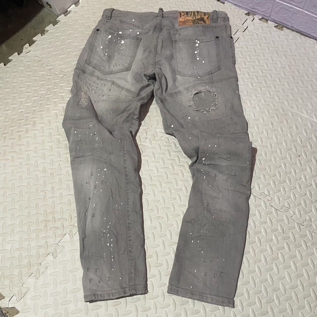 DSQUARED2 Grey Paint Splatter Distressed Denim Jeans (Category: Jeans) located in Zamboanga. Submitted by selvege (Listing ID 1460647928, Image 2). Description: - Grey DSQUARED2 jeans - White paint splatter detail - Distressed and ripped design (front and back) - Unique patchwork on knees and lower legs - Button fly closure - Bold statement piece - size 33-36.