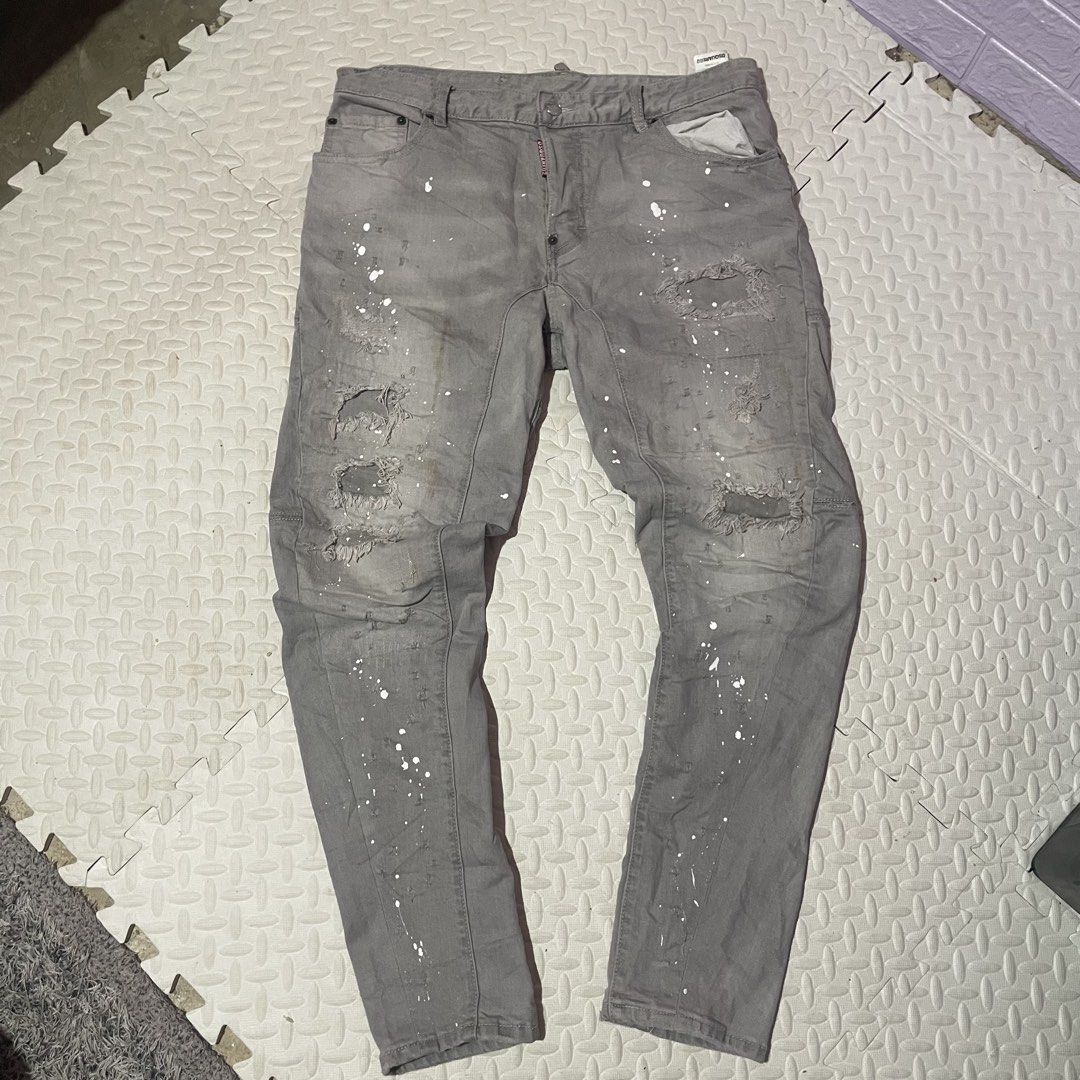 DSQUARED2 Grey Paint Splatter Distressed Denim Jeans (Category: Jeans) located in Zamboanga. Submitted by selvege (Listing ID 1460647928, Image 1). Description: - Grey DSQUARED2 jeans - White paint splatter detail - Distressed and ripped design (front and back) - Unique patchwork on knees and lower legs - Button fly closure - Bold statement piece - size 33-36.