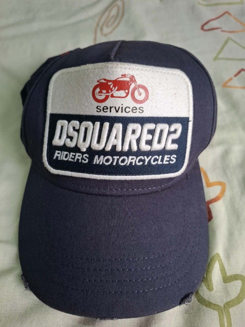 DSQUARED2 Riders Motorcycles Cap Navy Blue (Category: Caps & Hats) located in Quezon City. Submitted by erwinmichael25 (Listing ID 1460576339, Image 1). Description: - Brand: DSQUARED2 - Color: Navy Blue - Design: 'Riders Motorcycles' and 'Services' patch with motorcycle graphic - Embroidery: 'RIDING BEFORE WE COULD WALK' in red on the back - Features: Adjustable strap for a comfortable fit - Origin: Made in China for fast transaction 09171542915