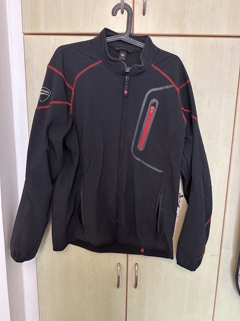 Ducati technical softshell jacket (Category: Coats, Jackets and Outerwear) located in Quezon City. Submitted by mancave_stuff (Listing ID 1460532793, Image 2). Description: -Ducati technical Softshell jacket -Stealth black color -Red contrast stitching with zippered chest pocket -Size L: W21.5 x L27” -Rainproof -Style: Can be used for urban moto rides and casual wear -No issues -Personal collection.