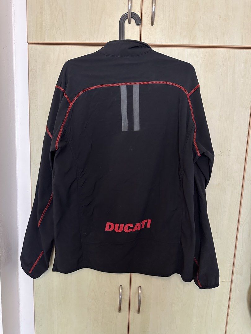 Ducati technical softshell jacket (Category: Coats, Jackets and Outerwear) located in Quezon City. Submitted by mancave_stuff (Listing ID 1460532793, Image 3). Description: -Ducati technical Softshell jacket -Stealth black color -Red contrast stitching with zippered chest pocket -Size L: W21.5 x L27” -Rainproof -Style: Can be used for urban moto rides and casual wear -No issues -Personal collection.