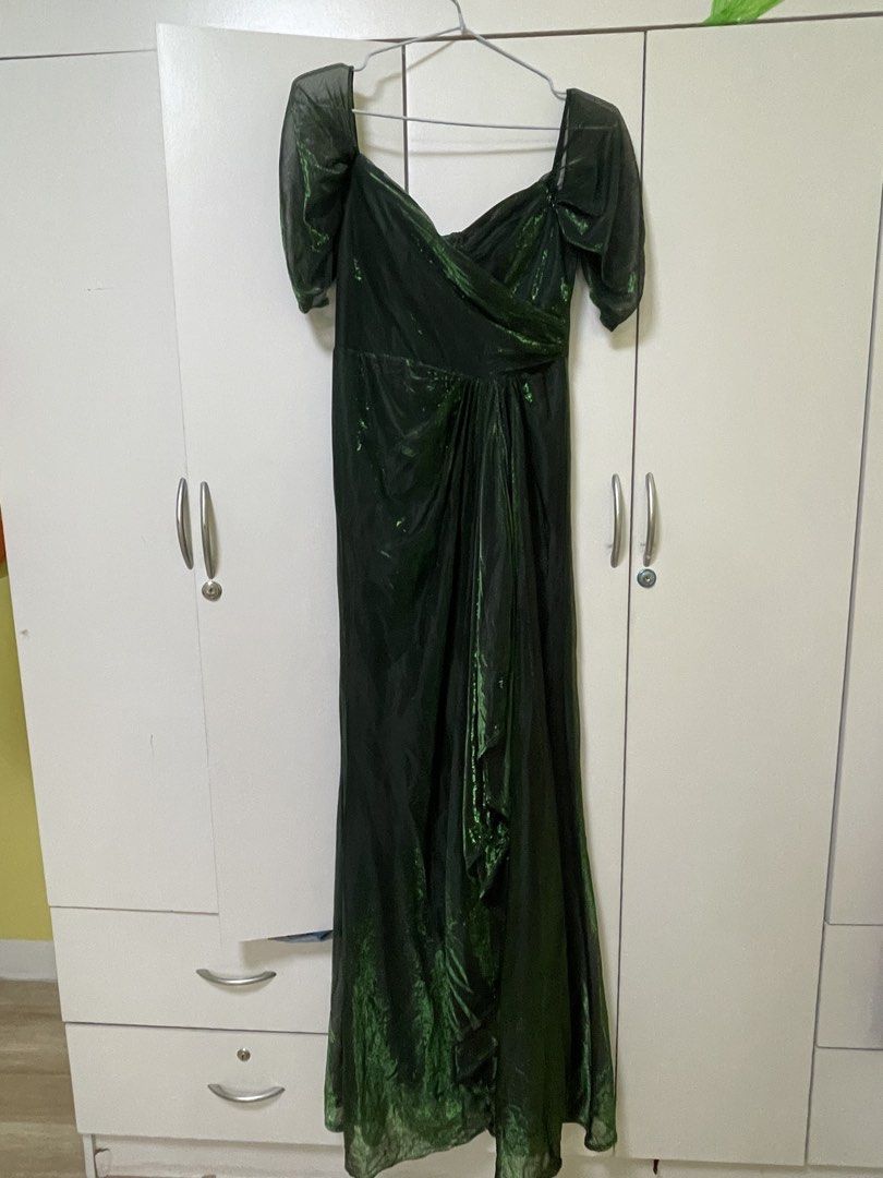 Emerald Green Off-Shoulder Ruched Gown (Category: Evening dresses & gowns) located in Quezon City. Submitted by dwynhnd (Listing ID 1441736878, Image 3). Description: - Beautiful emerald green gown - Off-shoulder design with ruched detailing - Subtle shimmer in the fabric - Floor length - Ideal for formal events or parties - Worn only once for a special occasion.
