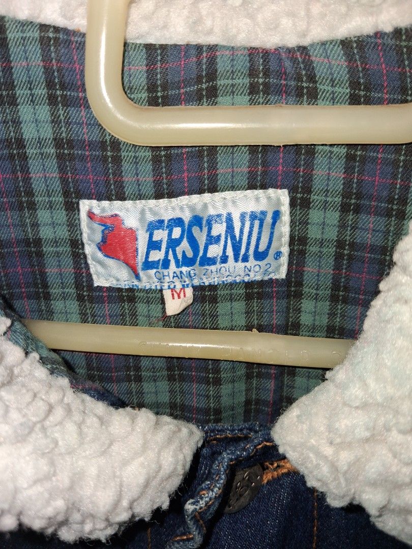 ERSENIU Denim Jacket with Sherpa Collar (Category: Coats, Jackets and Outerwear) located in Baguio. Submitted by arowarwai (Listing ID 1460664892, Image 2). Description: - Classic blue denim jacket - Warm sherpa collar for extra coziness - Lined with a green and blue plaid pattern - Button-up front - Features chest pockets - Ideal for layering in cooler weather - Easy to style.