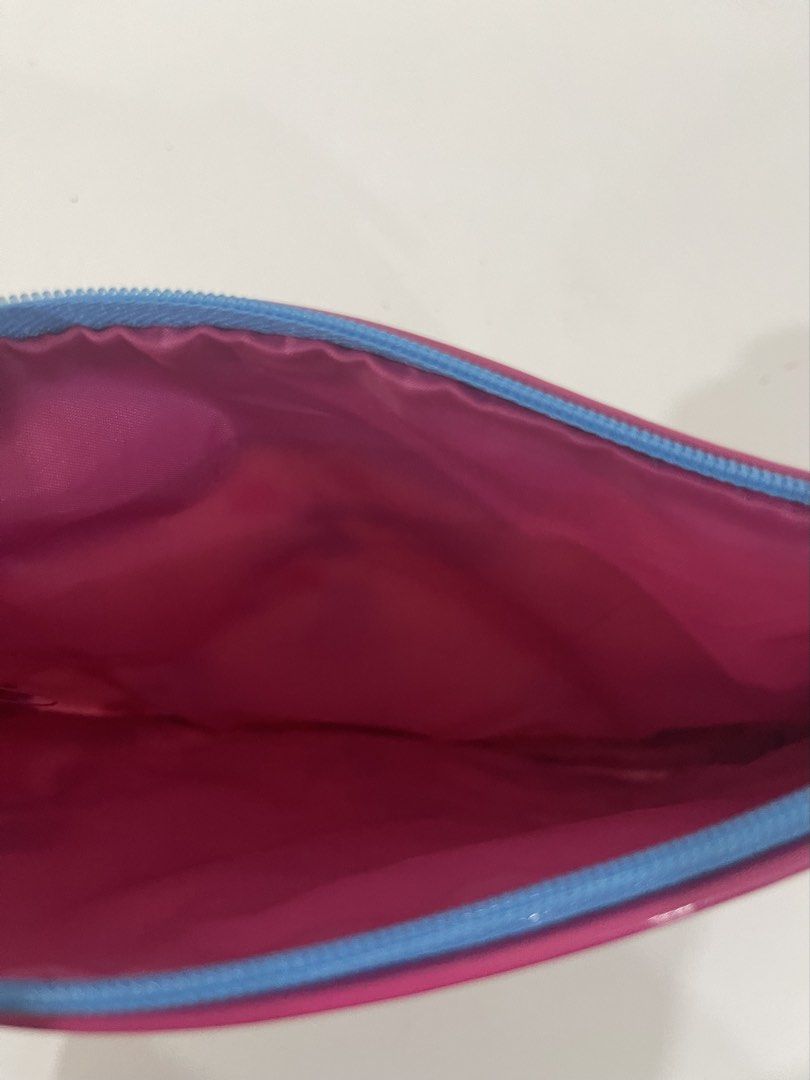 Estee Lauder Cosmetic Bag Pouch (Category: Purses & Pouches) located in Pasig City. Submitted by tinylittlestore (Listing ID 1460714549, Image 3). Description: - Cute Estee Lauder makeup pouch - Fun graphic print featuring a woman and polka dots - Color: Blue and pink exterior - Zipper closure with a pink Estee Lauder pull tab - Bright pink interior - Ideal for organizing makeup or toiletries.