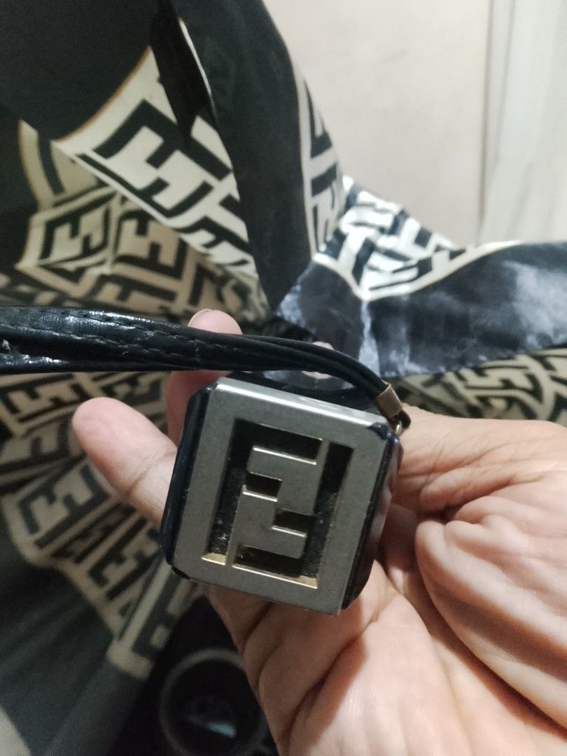 Fendi Monogram Folding Umbrella (Category: Umbrellas) located in Cagayan de Oro. Submitted by brex7 (Listing ID 1460513734, Image 3). Description: - Authentic Fendi monogram umbrella - Classic black and cream colorway - Compact and foldable design - Features Fendi logo on the handle - Includes a convenient wrist strap - Secured with a branded clasp - Ideal for unexpected rainy days.