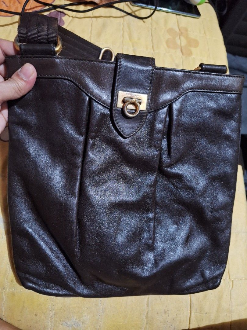 Ferragamo Vintage Sling bag (Category: Other Accessories) located in Quezon City. Submitted by cloudymay (Listing ID 1460507584, Image 2). Description: - Authentic Ferragamo vintage sling bag - Made in Italy - Genuine leather material - Classic and elegant design - Pre-loved item, showing signs of wear consistent with age - Iconic Ferragamo hardware - Perfect for everyday use or special occasions -Flaw: see closure strap, leather tearing. .
