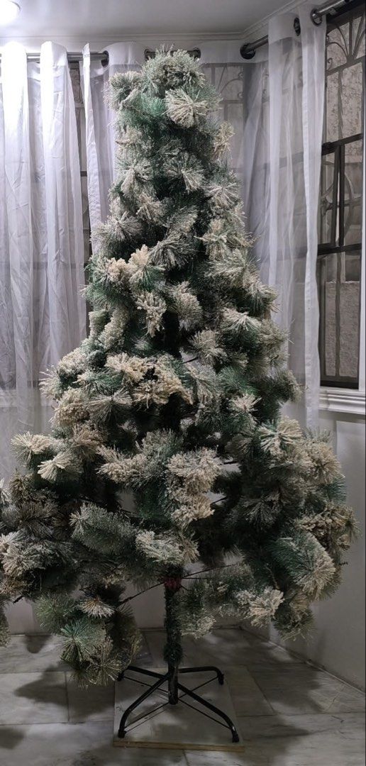 Flocked Artificial Christmas Tree with Stand (Category: Other Home Decor) located in Meycauayan. Submitted by treizie (Listing ID 1460511379, Image 1). Description: - pre-owned Flocked Christmas tree with a snowy, winter wonderland effect. 6ft - Pre-decorated branches for a festive look. - Comes with a sturdy metal stand for easy setup. - Perfect for adding your own ornaments and lights. - Creates a cozy and festive atmosphere in your home..