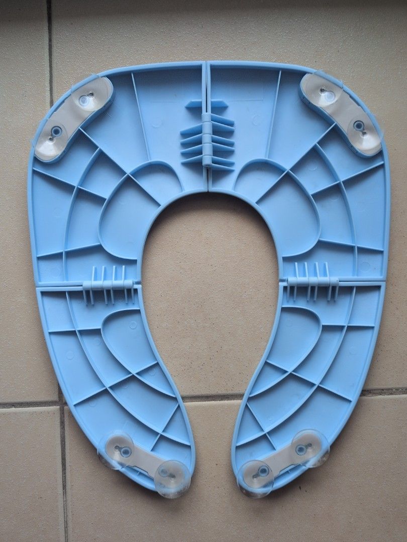 Foldable Baby Toilet Seat Reducer (Category: Bathtub & Bath Accessories) located in Pasig City. Submitted by jaym.austria (Listing ID 1460510341, Image 2). Description: - Light blue toilet seat reducer for potty training - Ideal for 2 years old who are potty training - Suction cups on the bottom for added stability - Folds for convenient storage. We bring this when we are travelling or going outside RFS: Outgrown already - Perfect for transitioni