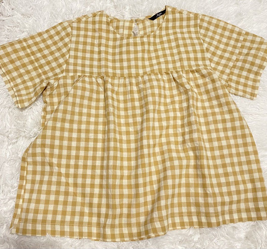 Forme Yellow Gingham Babydoll Top (Category: Sleeveless) located in Pasig City. Submitted by jnnnngg (Listing ID 1460680253, Image 1). Description: - Adorable yellow gingham pattern - Short sleeves for comfort - Flattering gathered empire waist - Chic keyhole detail at the back neck - Lightweight fabric, ideal for hot weather - Versatile: pairs easily with jeans or shorts.