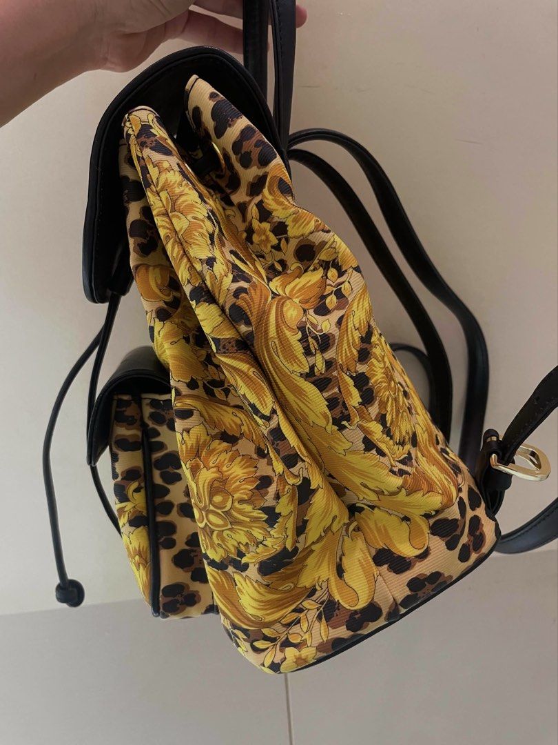 Gianni Versace Leopard Backpack (Category: Luxury Bags & Wallets) located in Manila. Submitted by thevintagebow (Listing ID 1460709459, Image 2). Description: Wild luxury, zero compromise. 🐆 ✨ Elevate your everyday streetwear with this high-fashion archive energy. This bag features the signature Gianni Versace yellow barocco print, wild leopard motifs, black leather trim, and gorgeous gold-tone hardware. Truly compact, chic, and undeniably iconi