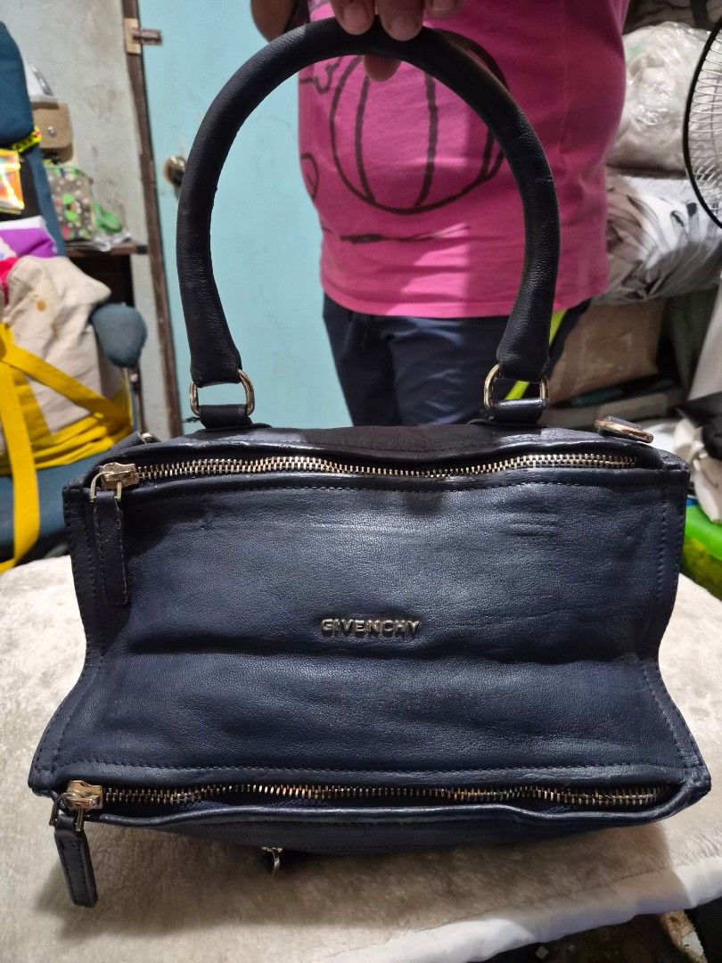 Givenchy pandora Navy Leather Handbag (Category: Other Baby Bathing & Changing Needs) located in Mandaue City. Submitted by chuchi152615 (Listing ID 1460623106, Image 1). Description: - Brand: Givenchy - Color: Navy Blue - Material: Leather - Features: Top handles, detachable crossbody strap - Hardware: Gold-tone - Interior: Spacious, great for everyday essentials - Condition: Used, with some signs of wear on the leather.
