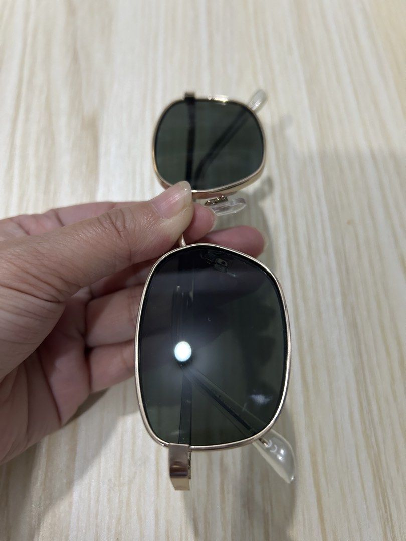 Gold Frame Square Sunglasses (Category: Sunglasses & Eyewear) located in Quezon City. Submitted by pinkisswear (Listing ID 1460693535, Image 1). Description: - Gold frame square sunglasses - Dark lenses for sun protection - Clear plastic arms - Clip-on design, ideal for attaching to existing eyeglasses.