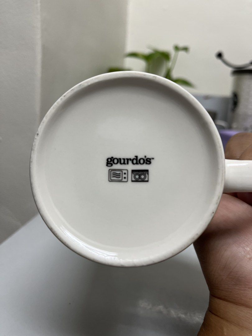 Gourdo's Mug - Funky Fish & Ocean Design (Category: Coffee & Tea Tableware) located in Manila. Submitted by closetperfection (Listing ID 1460664820, Image 1). Description: - Adorable fish and ocean theme - Perfect for coffee, tea, or any hot beverage - Dishwasher and microwave safe for convenience - Genuine Gourdo's product - Adds a fun, vibrant touch to your kitchen decor.