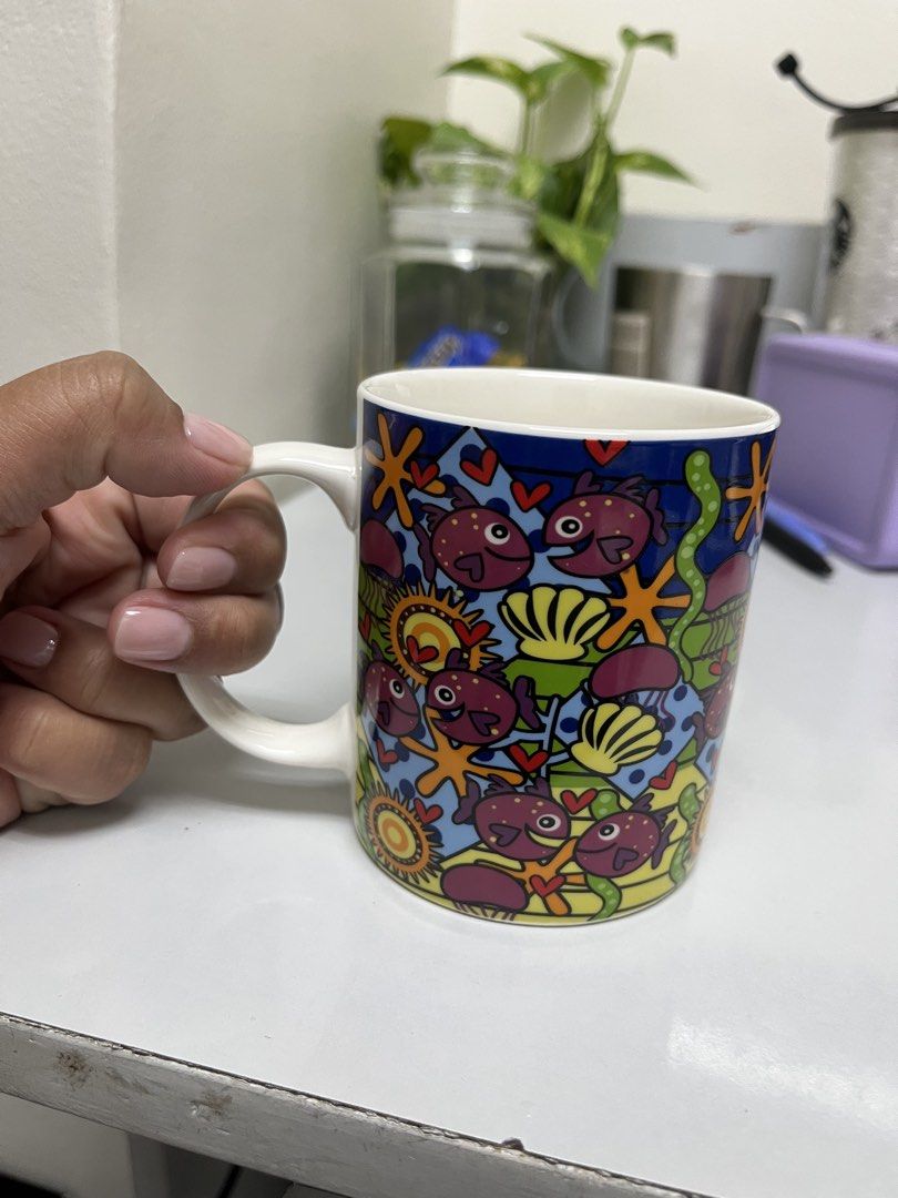 Gourdo's Mug - Funky Fish & Ocean Design (Category: Coffee & Tea Tableware) located in Manila. Submitted by closetperfection (Listing ID 1460664820, Image 2). Description: - Adorable fish and ocean theme - Perfect for coffee, tea, or any hot beverage - Dishwasher and microwave safe for convenience - Genuine Gourdo's product - Adds a fun, vibrant touch to your kitchen decor.