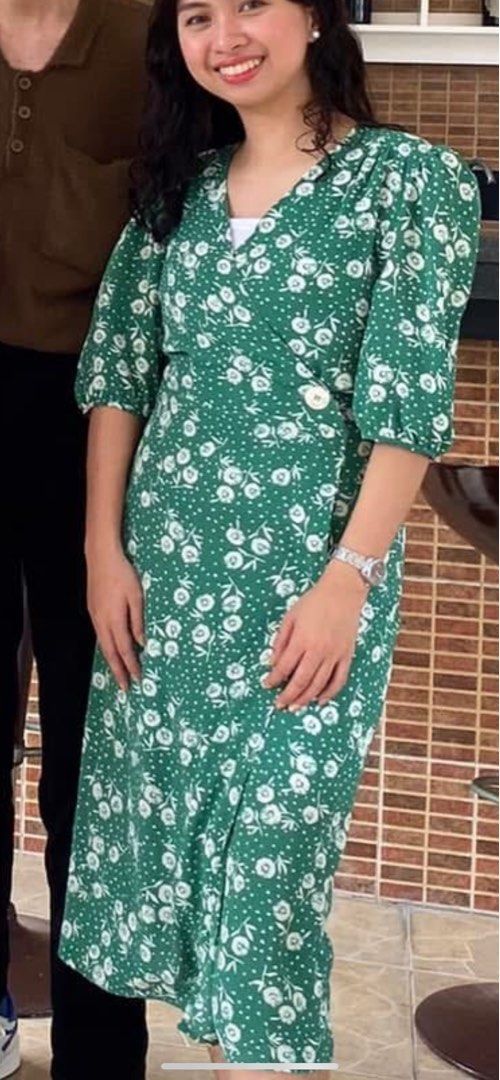 Green Floral Wrap Midi Dress (Category: Dresses) located in Caloocan City. Submitted by heybhaneyy (Listing ID 1460529201, Image 3). Description: - Green midi dress - White floral and polka dot print - Flattering wrap style - Side button closure - Puff sleeves - Midi length with a slit - Very flattering fit!.