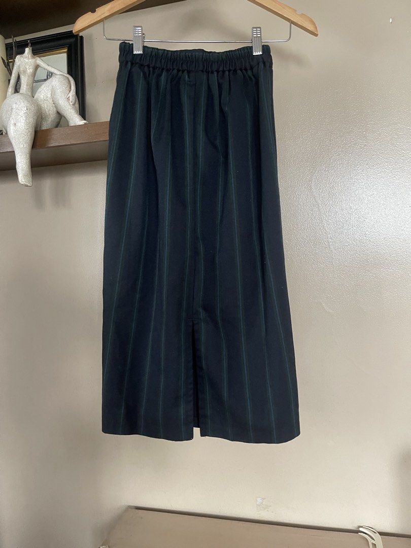 GU midi /pencil skirt (Category: Skirts) located in Quezon City. Submitted by booktt (Listing ID 1460649619, Image 3). Description: GU skirt small - a vertical striped midi/pencil skirt featuring a navy blue base with contrasting green and blue pinstripe detailing. It is tailored with a high-rise waist and a straight column silhouette..