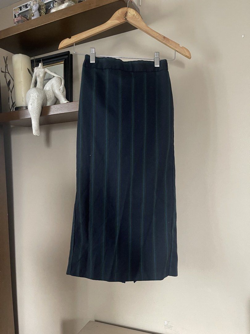 GU midi /pencil skirt (Category: Skirts) located in Quezon City. Submitted by booktt (Listing ID 1460649619, Image 1). Description: GU skirt small - a vertical striped midi/pencil skirt featuring a navy blue base with contrasting green and blue pinstripe detailing. It is tailored with a high-rise waist and a straight column silhouette..