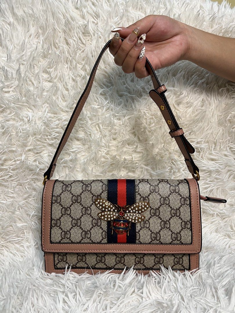 Gucci Monogram Bee Shoulder Bag (Category: Luxury Bags & Wallets) located in Manila. Submitted by yanya97 (Listing ID 1460543212, Image 1). Description: Classic Gucci monogram shoulder bag. Features the iconic GG pattern with a pink trim. Adorned with a cute bee embellishment on the front. The interior has multiple compartments and a zip pocket. Comes with a detachable strap. Great for everyday use or a night out..