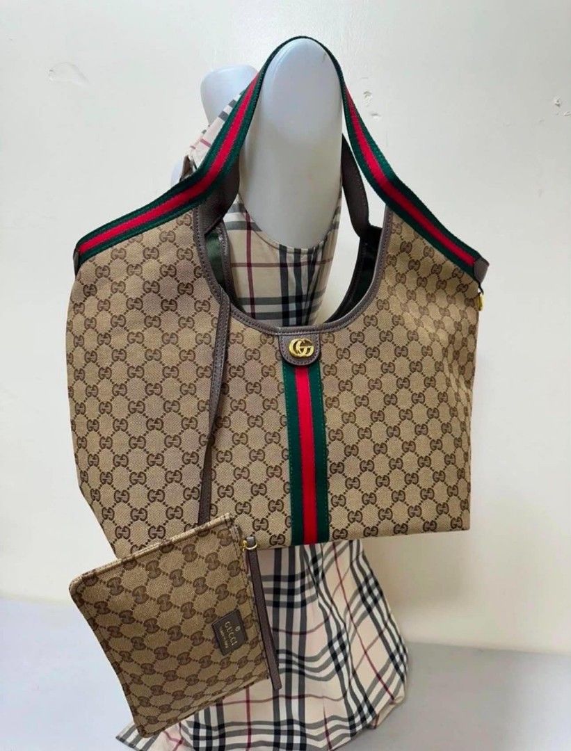 Gucci Monogram Canvas Hobo Bag with Pouch (Category: Luxury Bags & Wallets) located in Manila. Submitted by ukaygandamo (Listing ID 1460679512, Image 1). Description: - Gucci Hobo Bag - Classic GG Monogram Canvas - Signature Green and Red Stripe Detail - Includes Matching Pouch - Ideal for Everyday Use - Spacious Interior - Stylish Addition to Any Outfit.