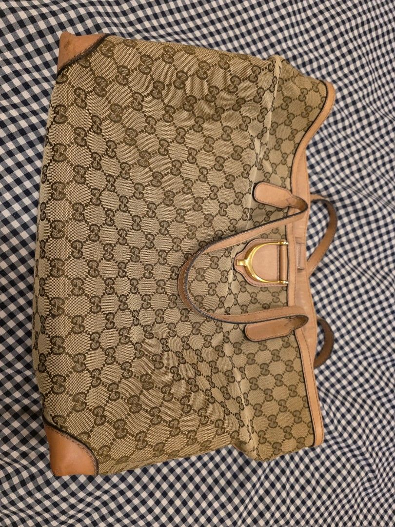 Gucci Monogram Canvas Tote Bag (Category: Luxury Bags & Wallets) located in Taytay. Submitted by brightdog.huskies (Listing ID 1460620573, Image 1). Description: - Authentic Gucci tote bag - Classic GG monogram canvas - Genuine leather trim and handles - Gold hardware details - Interior zip pocket - Serial number visible inside - Minor signs of wear on leather trim (bottom) and handles - Perfect for everyday use - Needs bag spa.