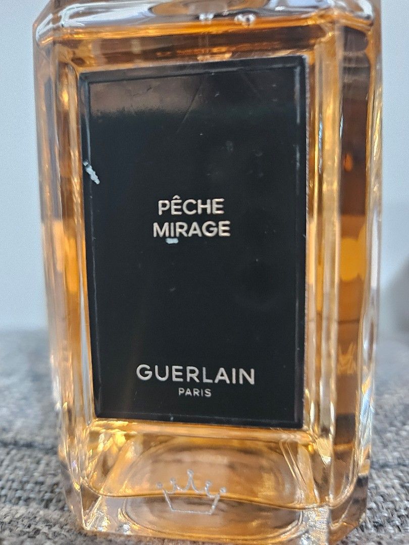 Guerlain Pêche Mirage Eau de Parfum 200ml (Category: Fragrance & Deodorants) located in Los Banos. Submitted by acleancloset (Listing ID 1460576049, Image 2). Description: - Guerlain Pêche Mirage Eau de Parfum - 200ml bottle, with engraved symbols in silver wax, label has some scratches - Authentic not a tester - Includes original box, batch code 4h01 no swaps, no layaways.