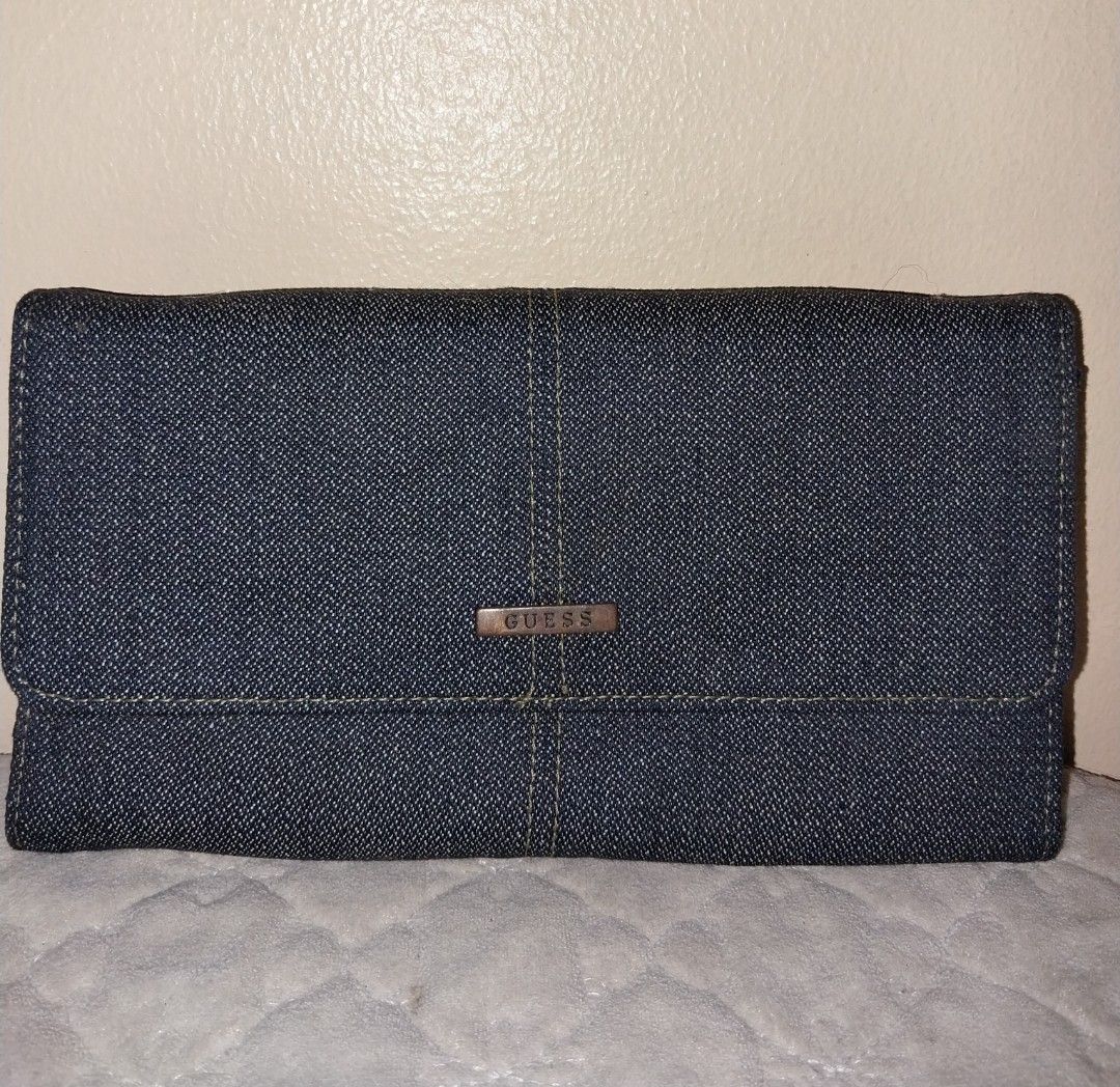 Guess Denim Wallet (Category: Wallets & Card holders) located in Manila. Submitted by PrinceDani.Clothing (Listing ID 1460567557, Image 1). Description: guess denim wallet 7.5in width 4.5in length issue: white stain back part excellent condition .